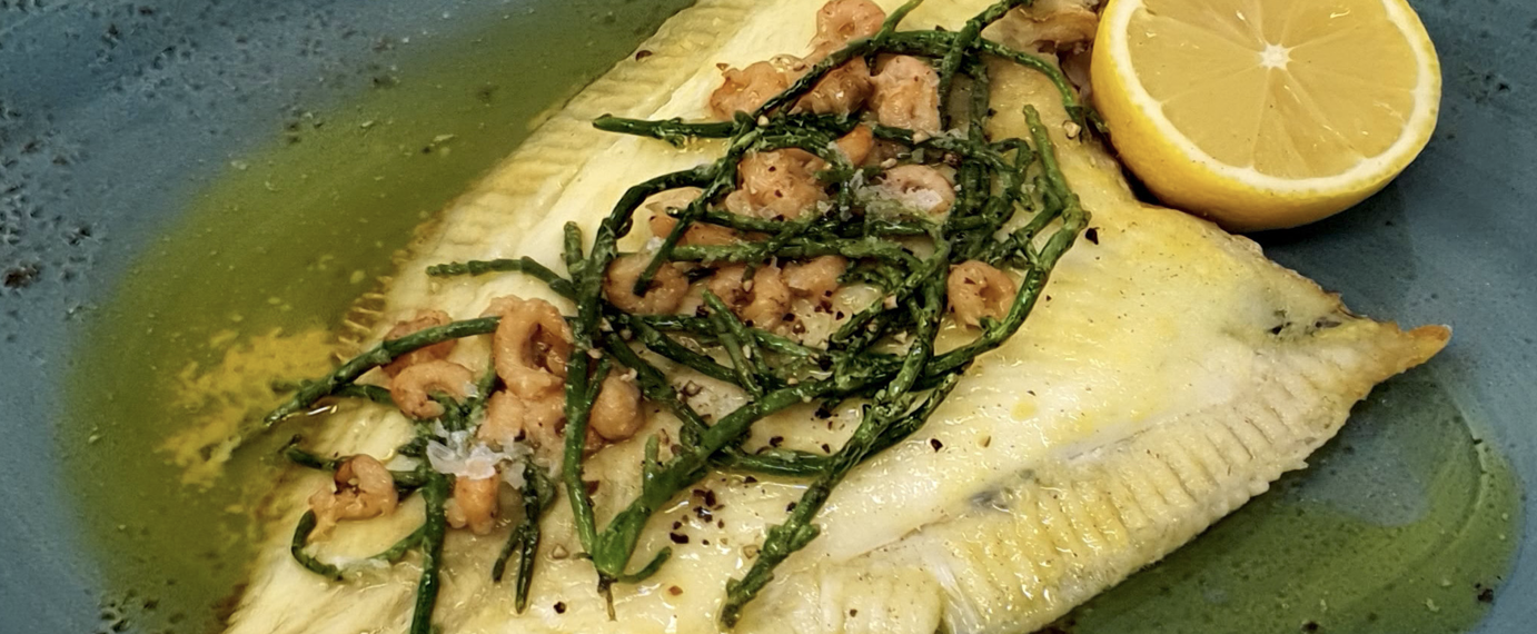 Grilled whole plaice with brown shrimp and samphire butter dish