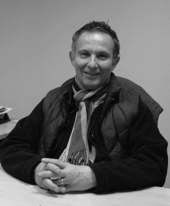 Laky sitting at a desk black and white profile picture