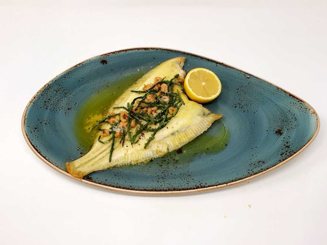 Grilled whole plaice with brown shrimp and samphire butter served